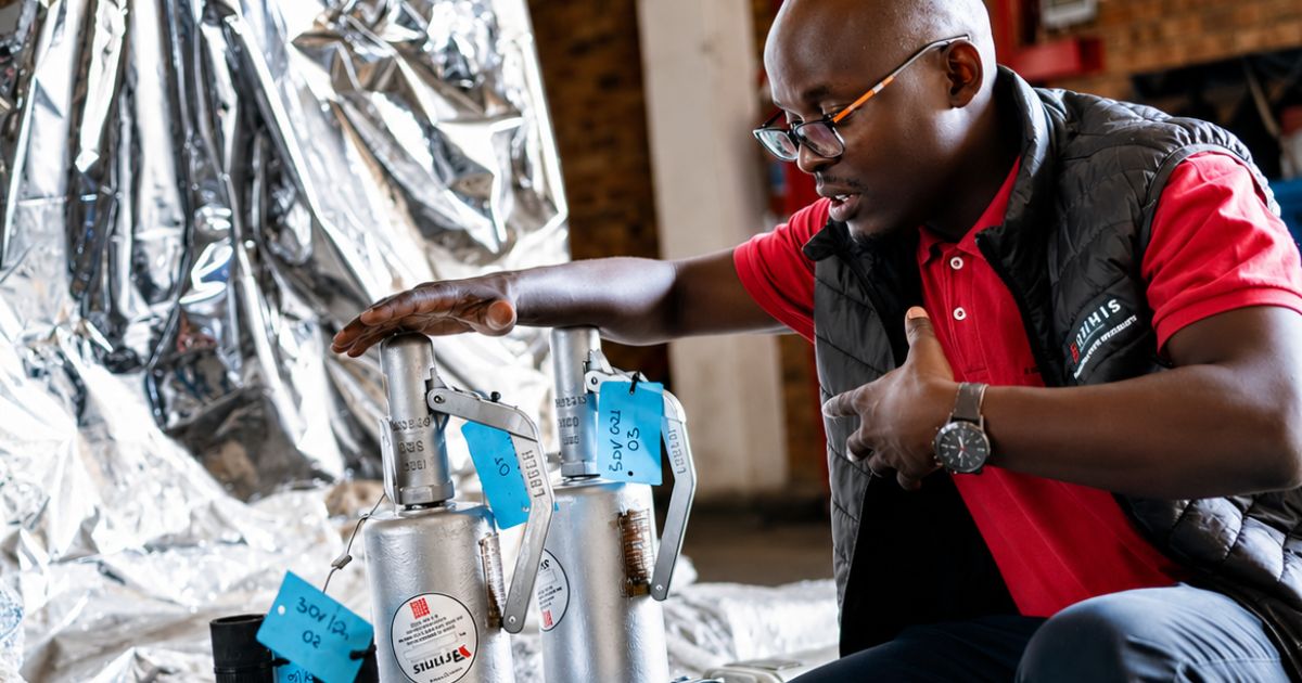 Industrial technician inspecting valve and mechanical components in a workshop, representing equipment reliability, lifecycle sustainment and critical systems operating beyond design life.